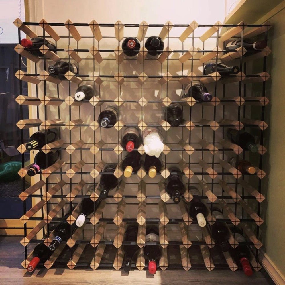 Partially filled timber wine rack with wine bottles